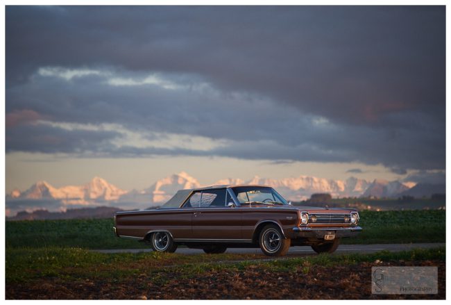 1966 Plymouth Satellite in front of snow capped mountains